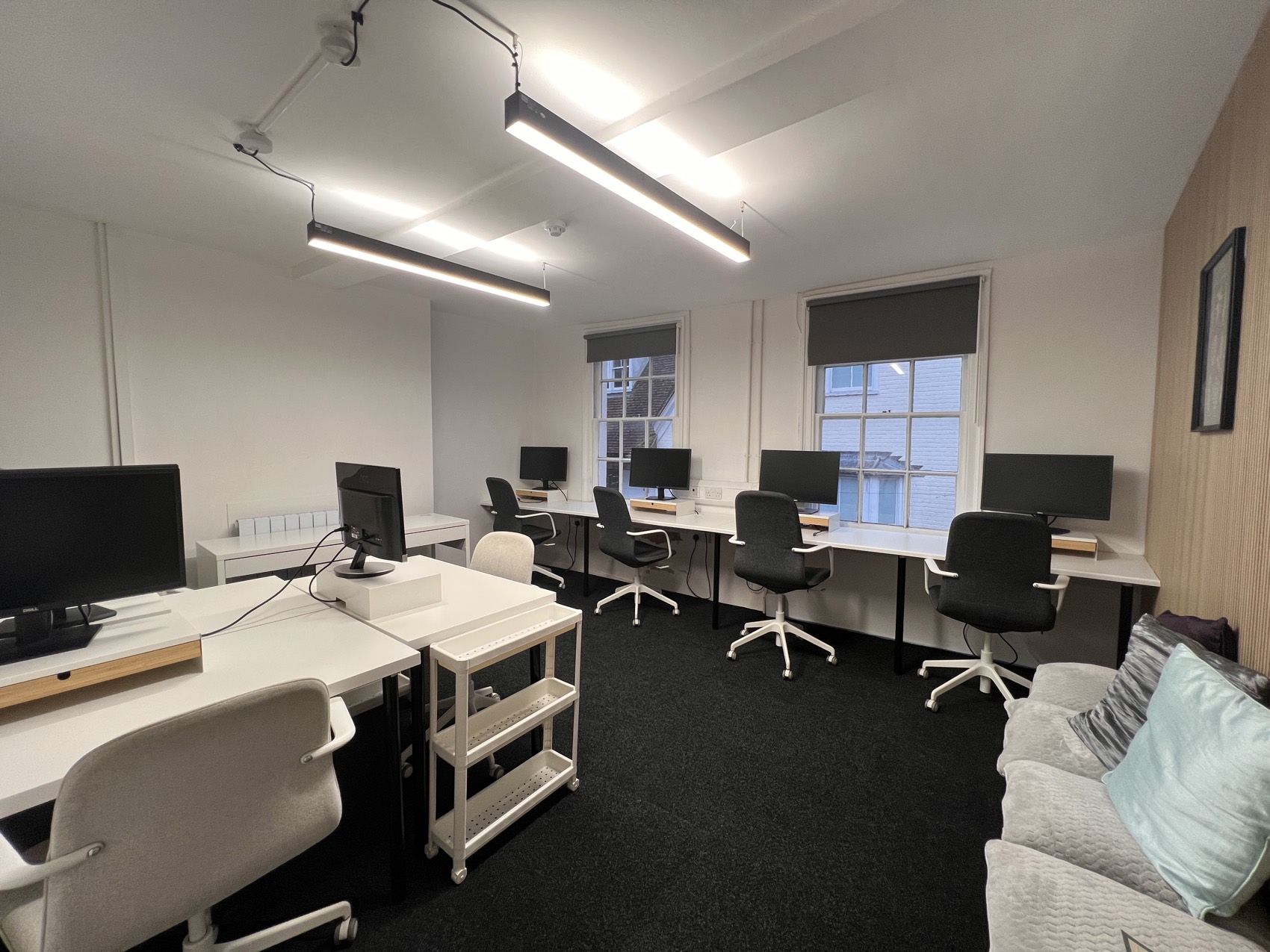 The Hop Yard — a bright team room with rows of monitor-equipped desks