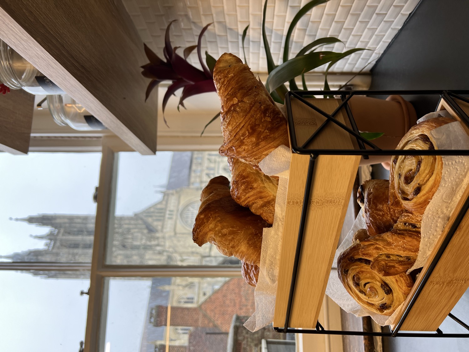 Complimentary pastries with Canterbury Cathedral framed in the café window