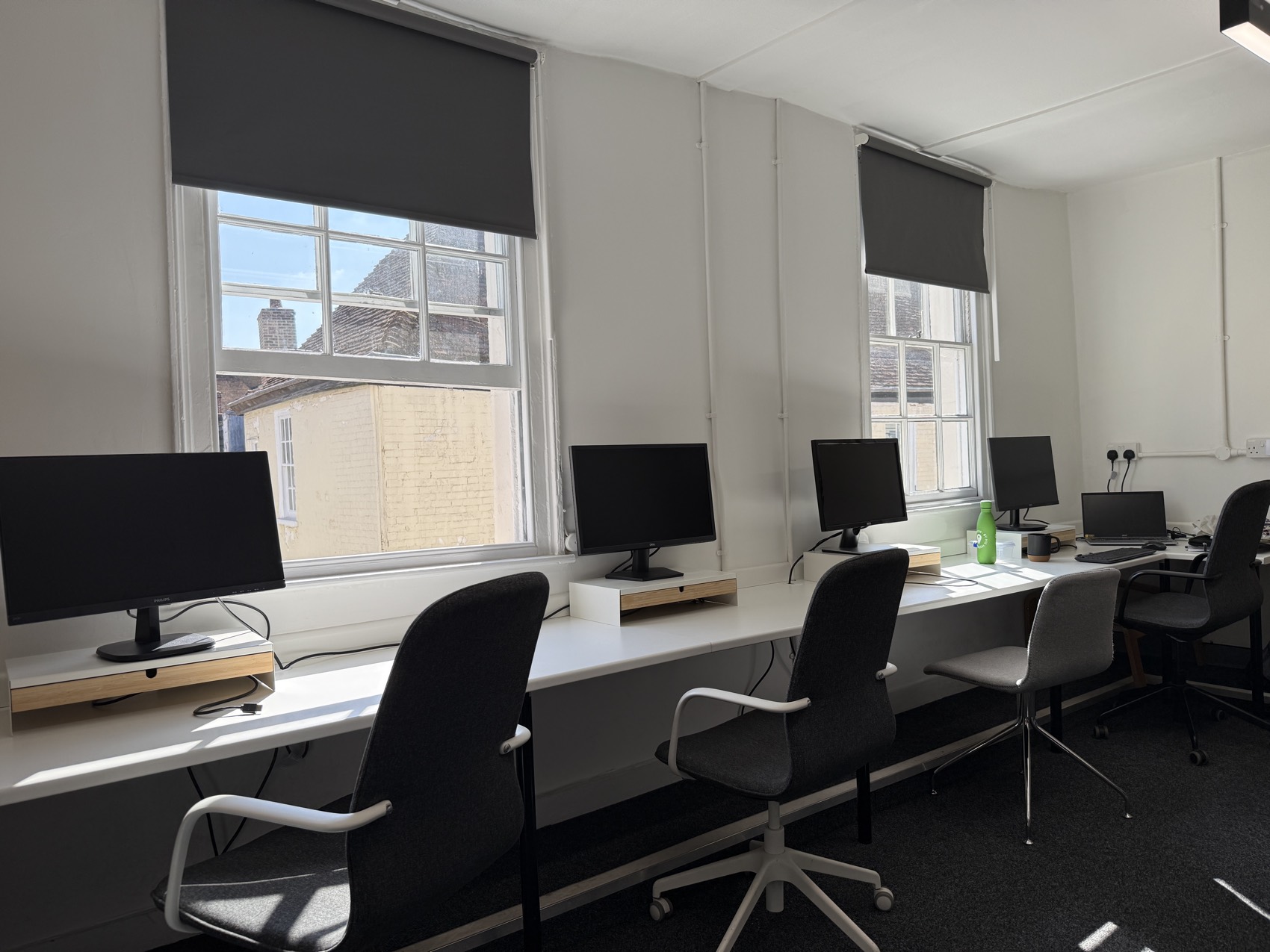 The Vineyard — a sunlit team room, desks at the window